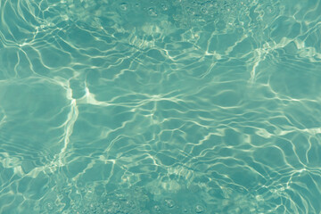 Blue water with ripples on the surface. Defocus blurred transparent blue colored clear calm water...