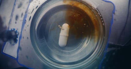 Medical science laboratory with modern equipment: Chemist adds liquid in glass flask. Top view on magnetic stirrer spinning and stirring fluid materials. High-tech lab device. Chemistry. Close Up Shot