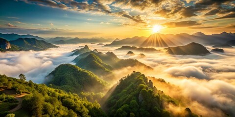 The serene morning sky bathes misty mountains in golden sunlight, as dawn breaks over their jagged peaks, offering a stunning aerial view that