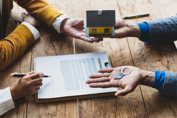 Legally signing a real estate agreement. Businessman negotiates with house sales agent before signing contract.