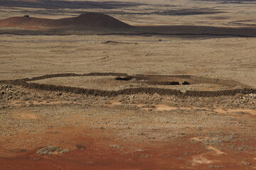 desertic landscape of volcano and caldera on the sea side