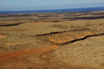 desertic landscape of volcano and caldera on the sea side