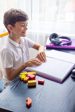 Children's hands on a Braille book &ndash; inclusion, blindness, disability. blind little boy reading braille book. Homeschooling. Inclusion