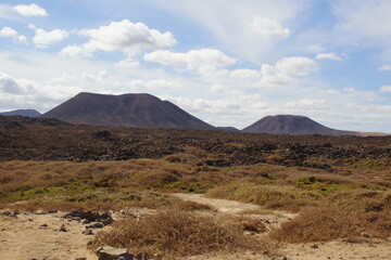 desertic landscape of volcano and caldera on the sea side