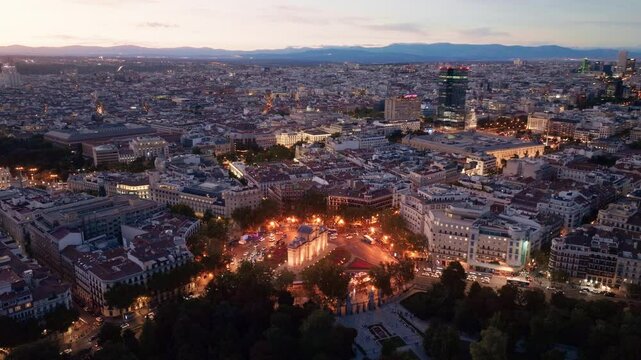 night Madrid drone view, downtown Madrid with night lights, Puerta de Alcala crossroads in Madrid in the evening aerial view, capital of Spain at night