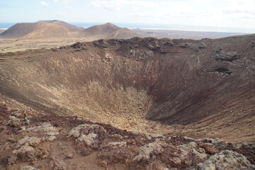 desertic landscape of volcano and caldera on the sea side