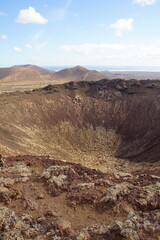 desertic landscape of volcano and caldera on the sea side