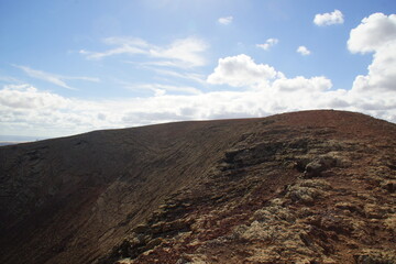 desertic landscape of volcano and caldera on the sea side