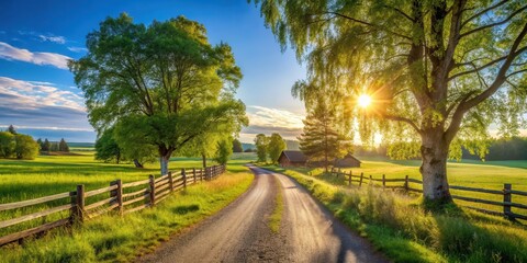 Obraz premium A tranquil countryside scene with a rustic wooden fence lining a winding dirt road leading towards a picturesque farmhouse bathed in the golden glow of a setting sun.