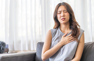 Sick asian women touching neck unwell coughing with sore throat pain,lung...