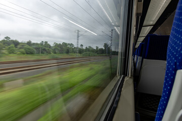 Passenger Train Window View During Daytime with motion blur