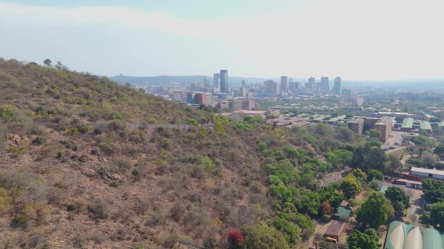Rise up, dry hill peels away to reveal Pretoria city skyline