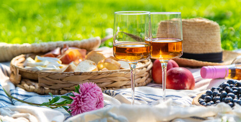 Glasses of wine at a picnic. Selective focus.