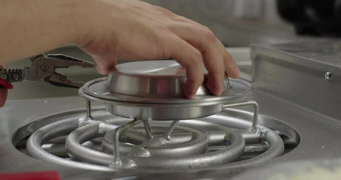 Traditional Turkish dessert kunefe preparation. Pastry chef flips kunafa in a copper plate on a gas stove
