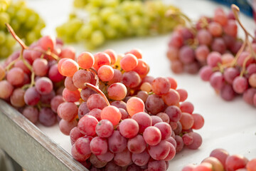 grapes displayed on a farmer's market counter