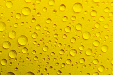 Close up of rain droplets on yellow cover background. Suitable for wallpaper background