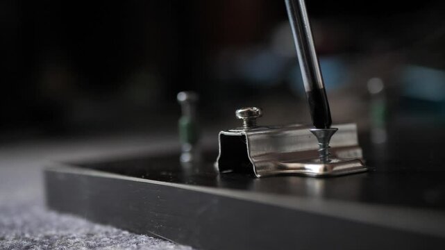 Installing hinges on a furniture door using a Phillips screwdriver. furniture assembly.