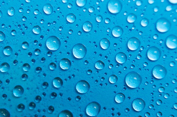 Close up of rain droplets on blue cover background. Suitable for wallpaper background