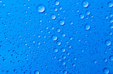 Close up of rain droplets on blue cover background. Suitable for wallpaper background