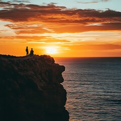 Silhouettes of two people enjoying a sunset over the ocean, creating a peaceful and reflective atmosphere.
