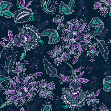 Seamless purple, blue and teal Paisley pattern on a navy blue background. Traditional batik flower motif for textile fabrics.