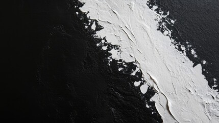 Obraz premium Abstract composition featuring a striking contrast of black and white textures, showcasing paint strokes and depth.