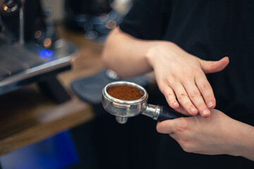 Close-up of hand Barista cafe making coffee. Barista with coffee.