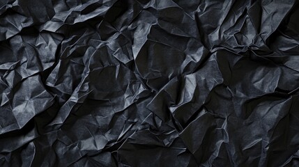 Textured black crumpled paper background, creating a dramatic and artistic visual.