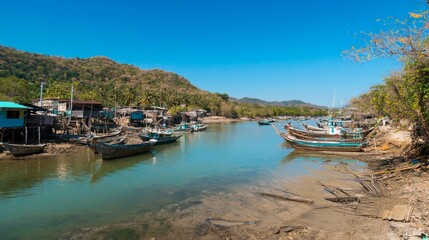 Fototapeta premium Serene Fishing Village: Unseen Thailand Landscape with Wooden Boats, Lush Hills, and Clear Blue Sky | Ultra Detailed Photography
