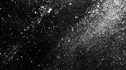 Obraz premium A mesmerizing display of white powder against a black backdrop, creating a stunning cosmic effect.