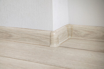 Decorative baseboard corner in empty room.