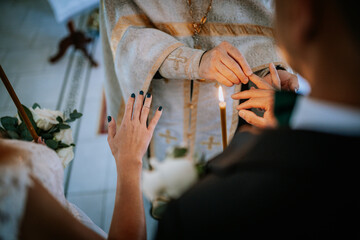 Close-up of the bride and groom exchanging rings during a wedding ceremony, symbolizing love and...