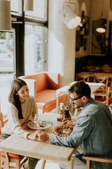 A joyful dinner date with delicious dishes and laughter in a cozy restaurant setting