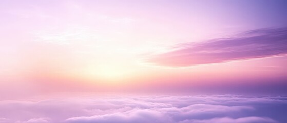 Fototapeta premium A serene sunrise with soft clouds painted in pastel hues of pink and purple.