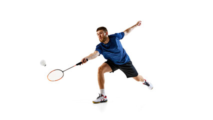 Focused and agile, young player stretches out to make shot. Playing badminton with determination, he closes in on shuttlecock. Concept of professional sport, focus and speed, championship.