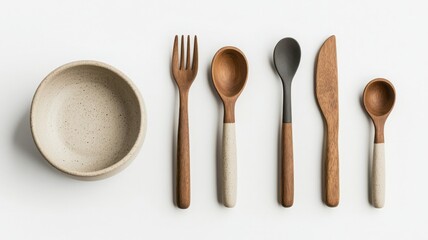 Wooden utensils and bowl arranged on a white background.