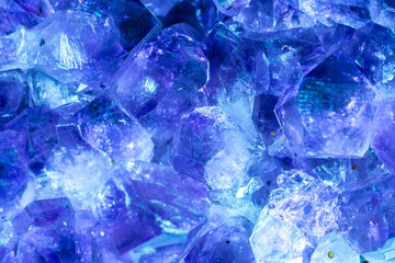 Blue Crystal Mineral Stone. Gems. Mineral crystals in the natural environment. Texture of precious and semiprecious stones. Seamless background with copy space colored shiny surface of precious stones