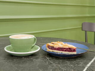 cappuccino and cake on the table in the restaurant