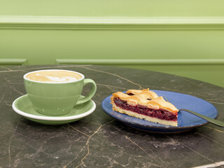 cappuccino and cake on the table in the restaurant