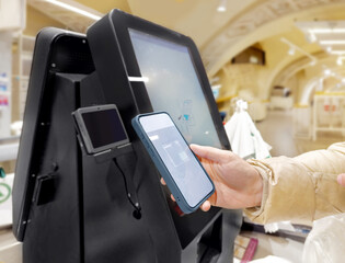 Customer pays his purchase at the supermarket,self checkout systems in  retail stores,Barcode scanner,Self checkout machine