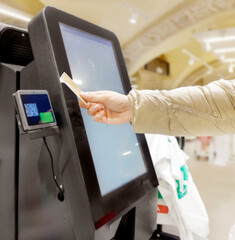 Customer pays his purchase at the supermarket,self checkout systems in  retail stores,Barcode scanner,Self checkout machine