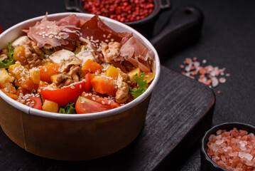 Appetizing salad with prosciutto, pumpkin, cheese and tomatoes