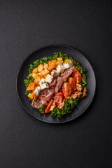 Appetizing salad with prosciutto, pumpkin, cheese and tomatoes