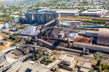 Cement plant view from above. Workshops and compressors, equipment, metallurgy. Technological work on cement production. Industrial production on a large scale.