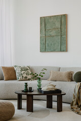 A modern, minimalist interior with a large sofa and natural accents. Soft greens bring harmony to...