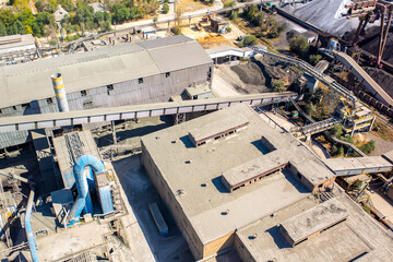 Cement plant view from above. Workshops and compressors, equipment, metallurgy. Technological work on cement production. Industrial production on a large scale.