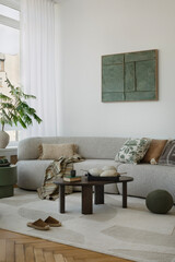 A modern interior with a cozy sofa and carefully selected details. Green accents and wooden...
