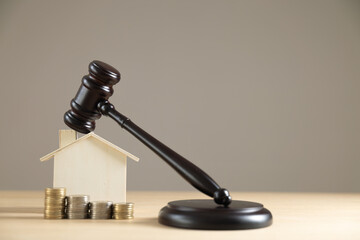 Judge auctions and the real estate legal system House model and gavel with icons on a wooden table Laws governing foreclosures and bankruptcies, debts or liens, divorces, inheritances