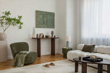 A spacious living room with natural accents in green and beige. Comfortable furniture and carefully chosen decor create a harmonious, calming space.