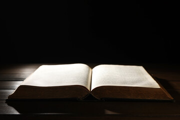 Open Bible on wooden table. Christian faith